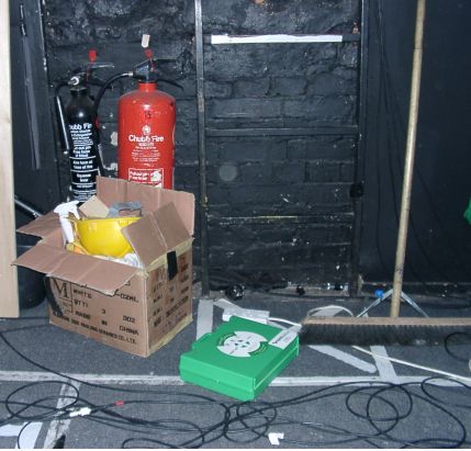 Fire extinguishers blocked in with flammables, tripping hazards, first aid box left on floor