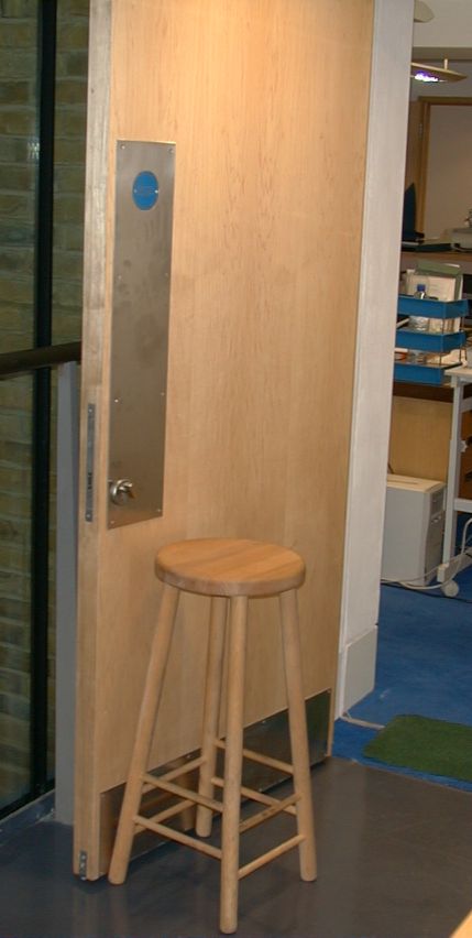 Stool being used to hold open a fire door